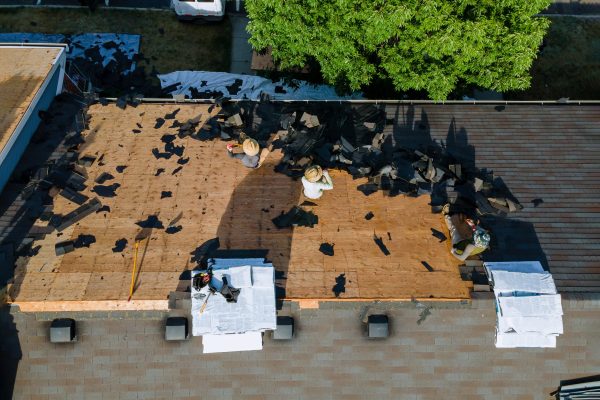 Working roofers on replacing the roof of residential building in the renovation roof the house